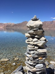 stone pillar with lake in background