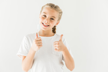 child holding toothbrush