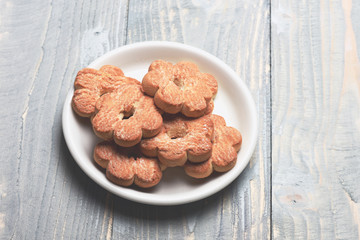 Tea cookies on grey wooden background. Composition of tiny gateau