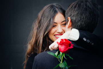 Beautiful couple in love with a rose