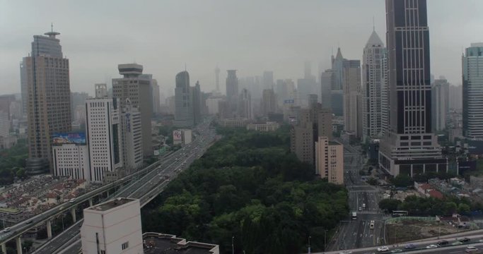 SHANGHAI, CHINA – JUNE 2016 : Aerial shot in Central Shanghai with view of cityscape, skyline, park and highway traffic