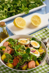 Healthy salad with salmon, potatoes, eggs and lamb's lettuce.