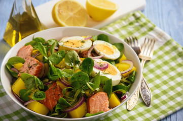 Healthy salad with salmon, potatoes, eggs and lamb's lettuce.