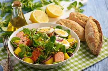 Healthy salad with salmon, potatoes, eggs and lamb's lettuce.