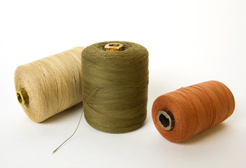 Multicolored old coils with threads.