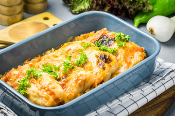 Paleo stuffed cabbage leaves casserole in a baking dish with ingredients. Selective focus, close up.