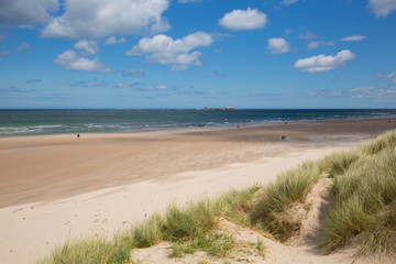 Northumberland beach and coast at Bamburgh north east England UK with view to the Farne islands tourist attraction