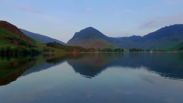 Lake and mountains at sunset in calm day in the Lake District, England