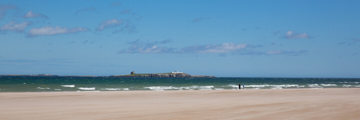 Northumberland beach and coast at Bamburgh north east England UK with view to the Farne islands panoramic view