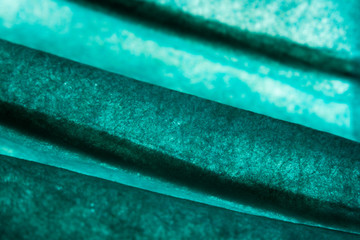 Abstract background of turquoise paper macro, photo