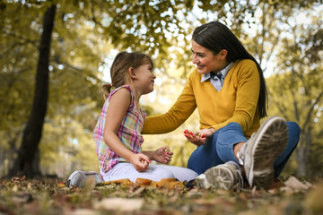 Fototapeta premium Mother and daughter spending time together. Autumn season.