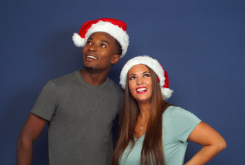 women man looking up christmas red hat santa claus december holiday party young couple