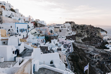 Fototapeta na wymiar View of famous white buildings of Oia town on cliff in Santorini, Greece