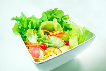 Top view of freshness vegetables in a white bowl on white background is ready meal for breakfast, lunch, dinner
