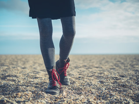 Legs of a woman walking on the beach in autumn