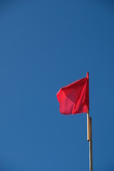 flags in the wind with blue sky