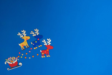 Santa's sleigh, with gifts, led by colorful reindeers