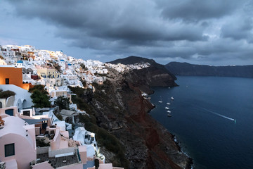 View of famous white buildings of Oia town on cliff in Santorini, Greece
