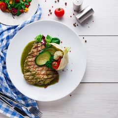 Grilled beefsteak with vegetables and green bell pepper sauce
