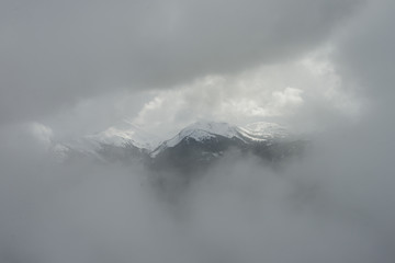 Fototapeta na wymiar View of mountain range covered with fog, Whistler, British Columbia, Canada