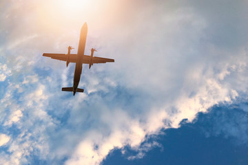 Airplane on the sky and sun with cloudy.