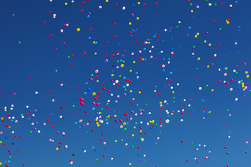 Colorful balloons on blue sky background.