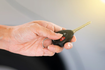 Hand holding remote car key.