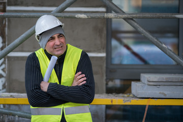 Engineer with protective workwear freezing outdoors