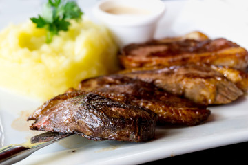 juicy steak beef meat with tomato and potatoes