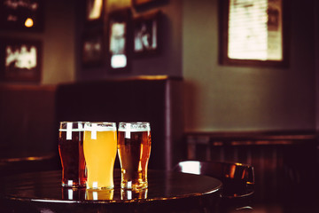 Glasses of light and dark beer on a pub background