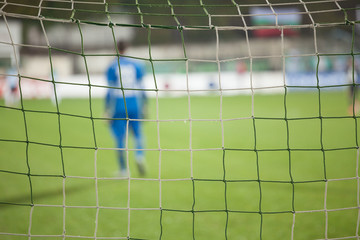 Football net during a football mach. Focus on the net