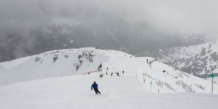 Skiers on snowy mountain, Whistler, British Columbia, Canada