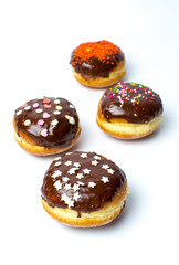 Decorated chocolate donuts on white background