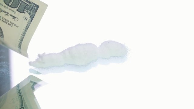 Cocaine powder on the one hudred dollar bank notes 