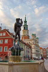 statue on the top of fountain and old city hall in Poznan, Poland