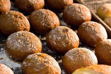 Freshly baked small hot rolls with raisins.