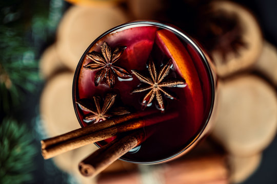 Christmas hot mulled wine in a glass with spices and citrus fruit. Mulled wine with cinnamon, anise and orange. 