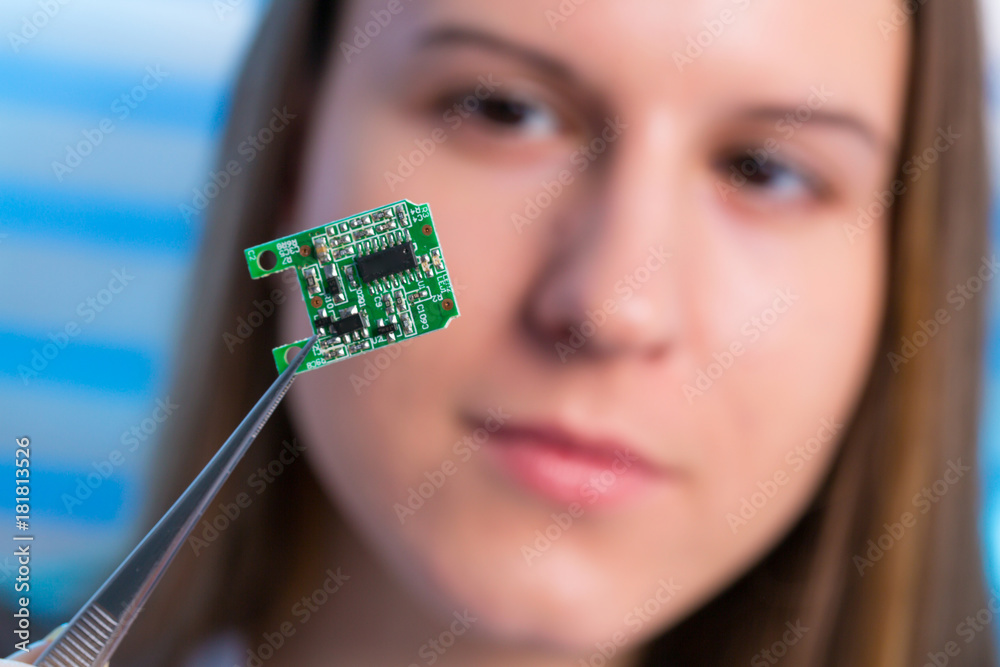 Canvas Prints Young woman fix PC component in service center