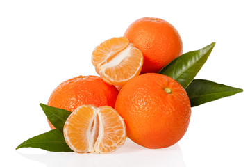 Orange Mandarines, Clementines, Tangerines or small oranges with one peeled and cut in half with leaves isolated on white background, cut out or cutout