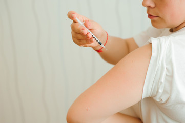 Insulin injection close-up. Girl injects insulin into his hand independently. Diabetes.
