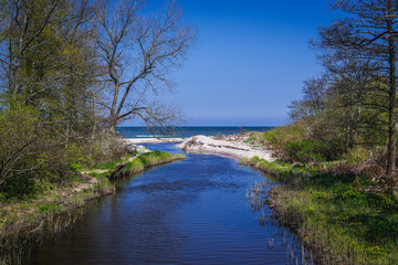Fototapeta na wymiar Small Czerwona River in West Pomerania region of Poland. Baltic Sea on background