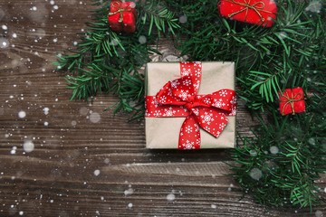 Christmas handmade  presents with red ribbon on wooden background