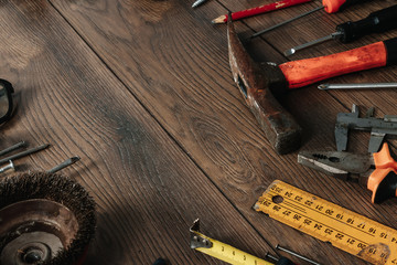 A construction tool on a brown wooden background. View from above. Picture background, screensaver. The concept of construction, repair, construction, production, design. Copy space.