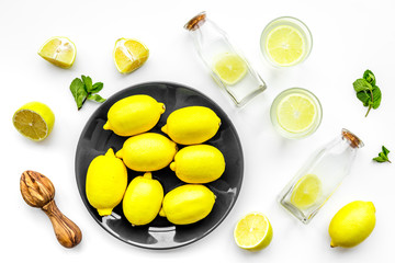 Fresh homemade lemonade. Lemons, juicer, glass for beverage on white background top view
