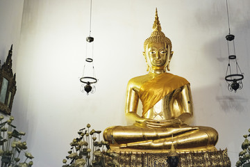 Big Golden Buddha In Lotus Position inside the hall of Wat Pho public temple, Bangkok, Thailand.