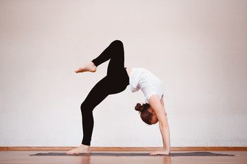 Yoga Concept. Close up woman meditates while practicing yoga in training hall or home.
