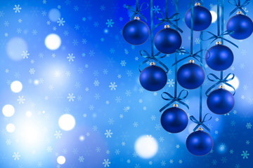 Christmas blue balls with ribbons on defocused background