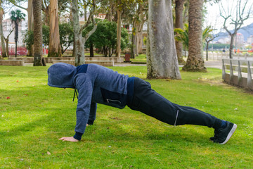 young man doing exercise in a park