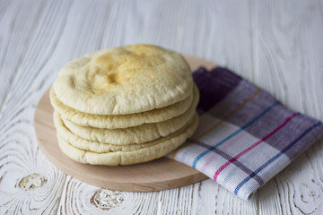 Pita or Arabic bread on white wooden table