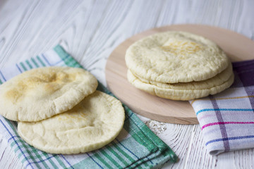 Pita or Arabic bread on white wooden table